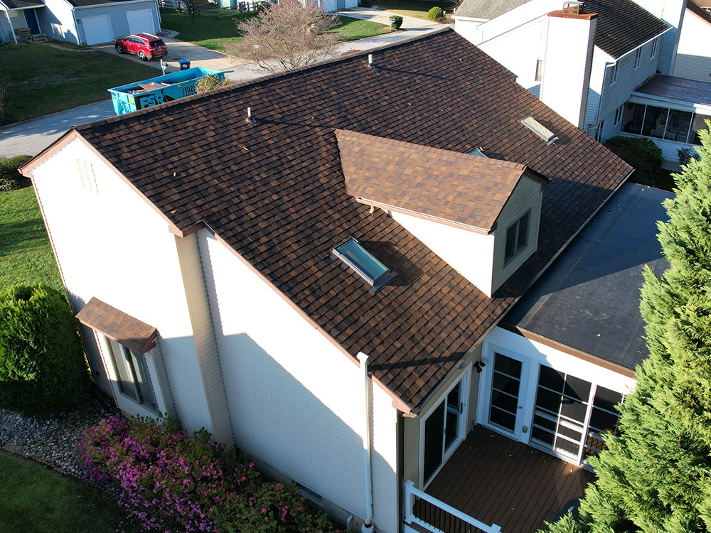 Roof repair in Drexel Hill, PA showing technicians repairing water-damaged roofing panels