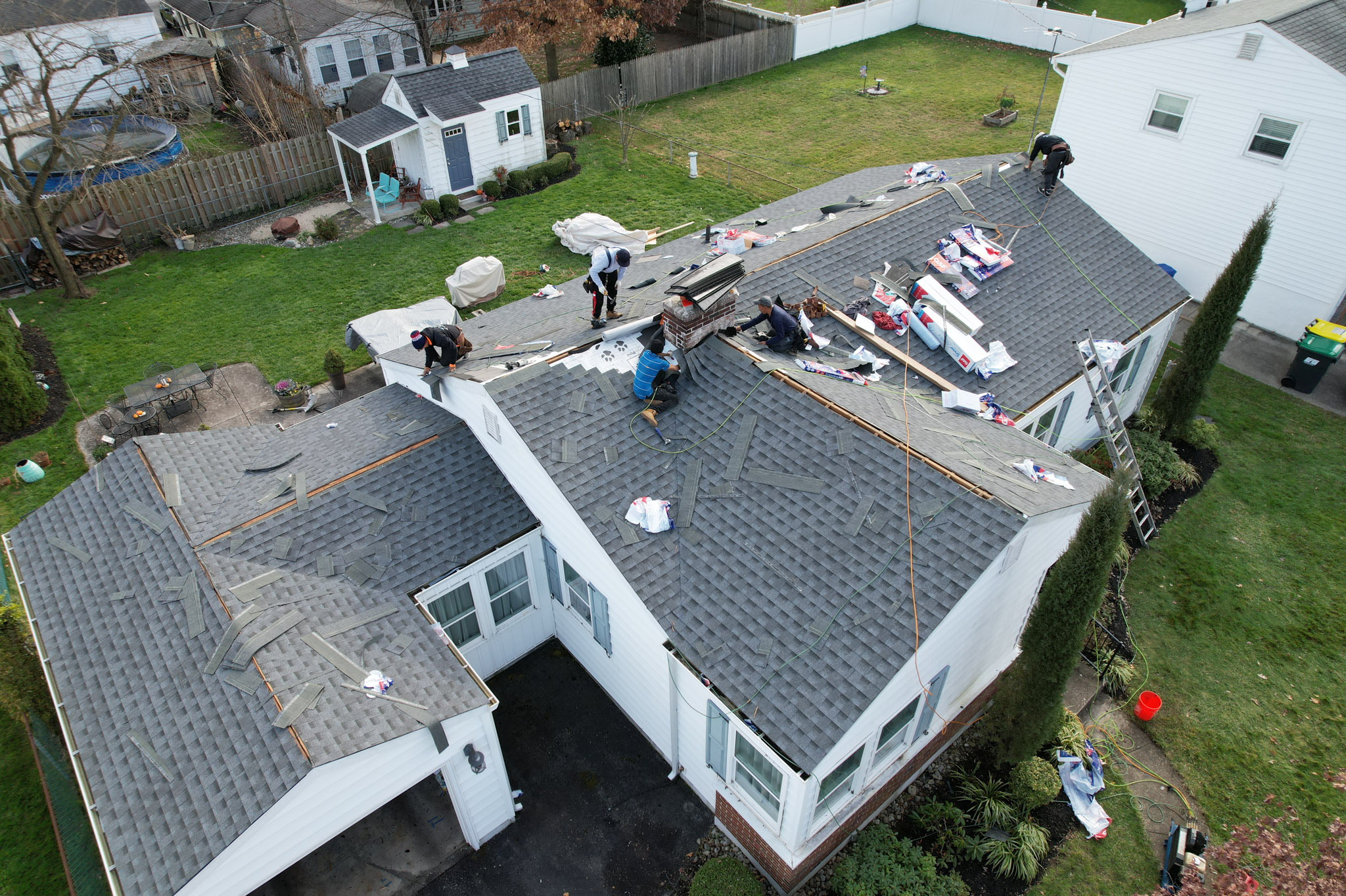 Roof repair near me in Swarthmore, PA showing a crew fixing a leaky roof