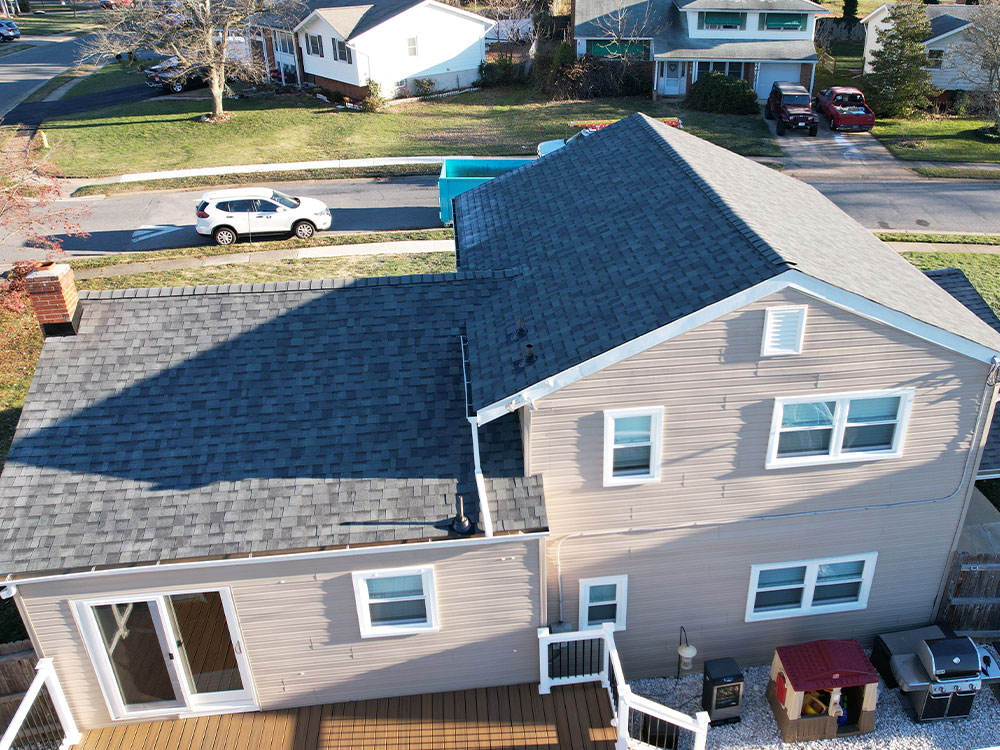 Roof repair services in Media, PA fixing water-damaged areas on a colonial-style house